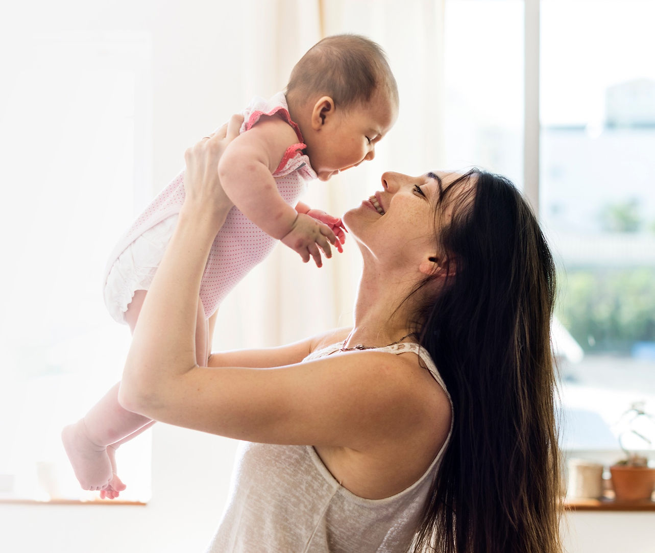 young-mom-holding-her-baby-air-blank-space_edited.jpg